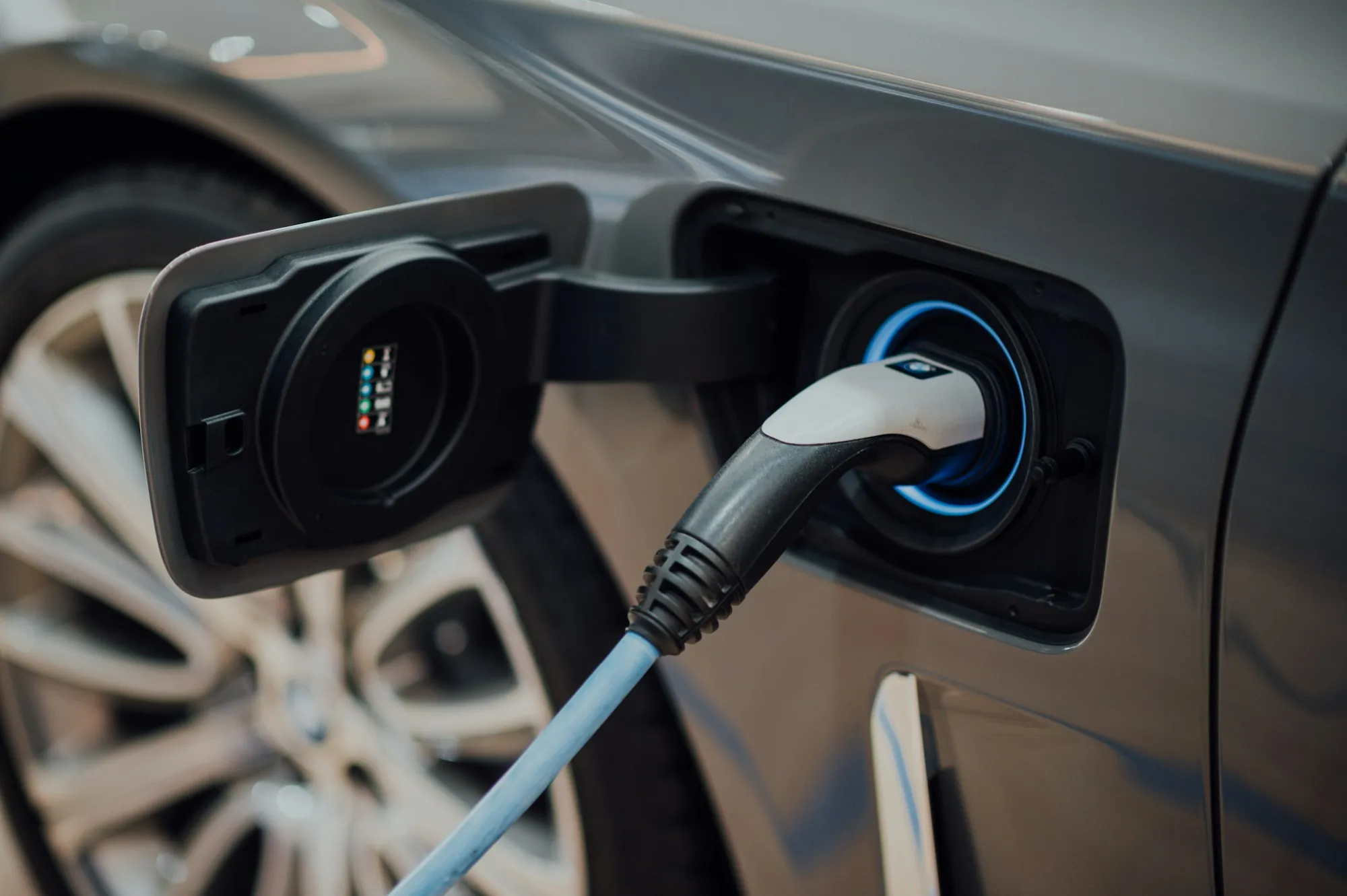 An electric vehicle charging on a city street